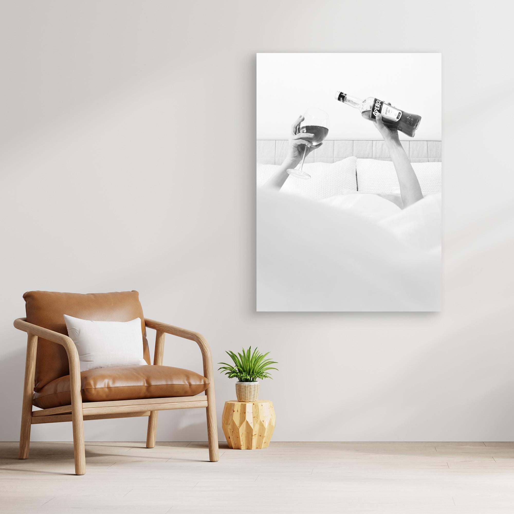 Modern interior with a brown leather chair, plant, and abstract art on the wall.