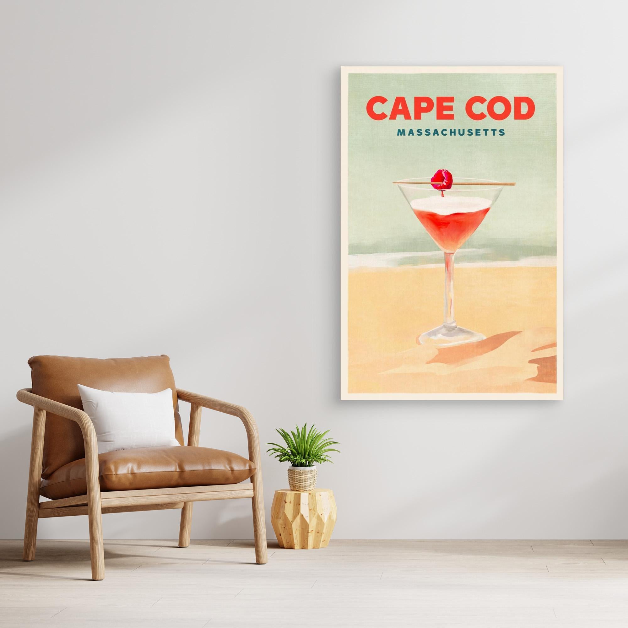 Print of a cocktail with 'Cape Cod Massachusetts' text in a room with a chair and plant.