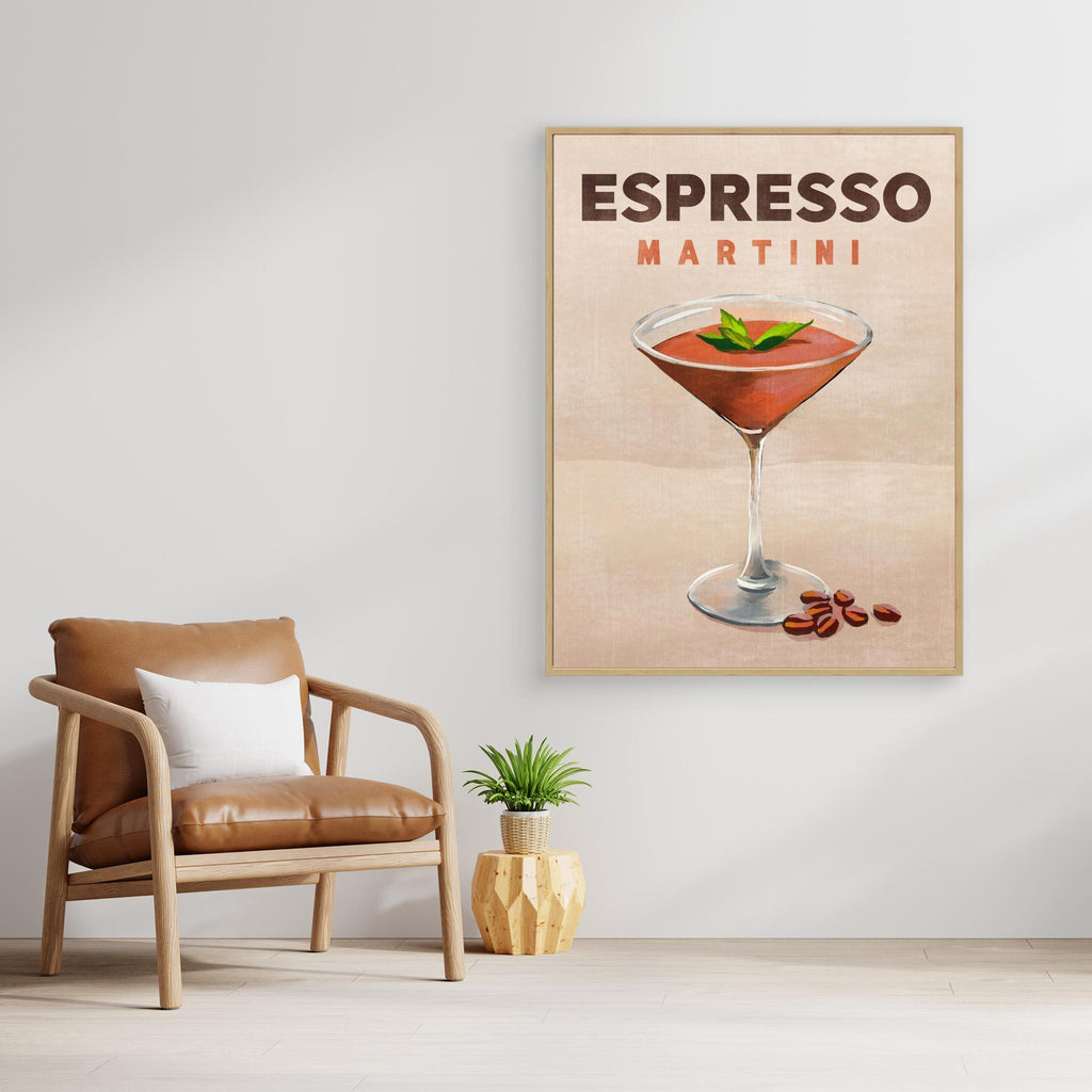 Framed artwork of an Espresso Martini on a wall above a brown armchair.