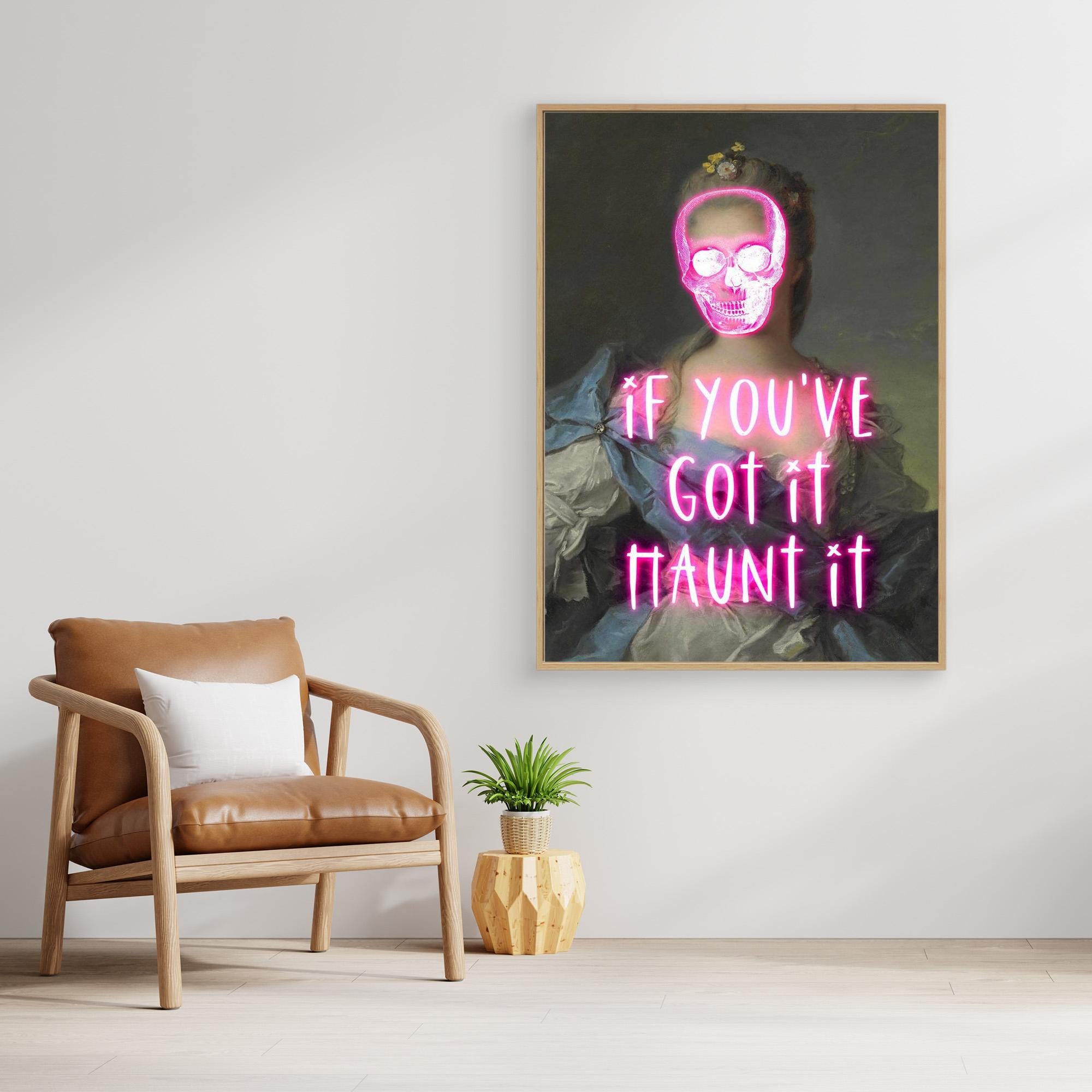Framed artwork with pink neon text on a wall above a brown armchair.