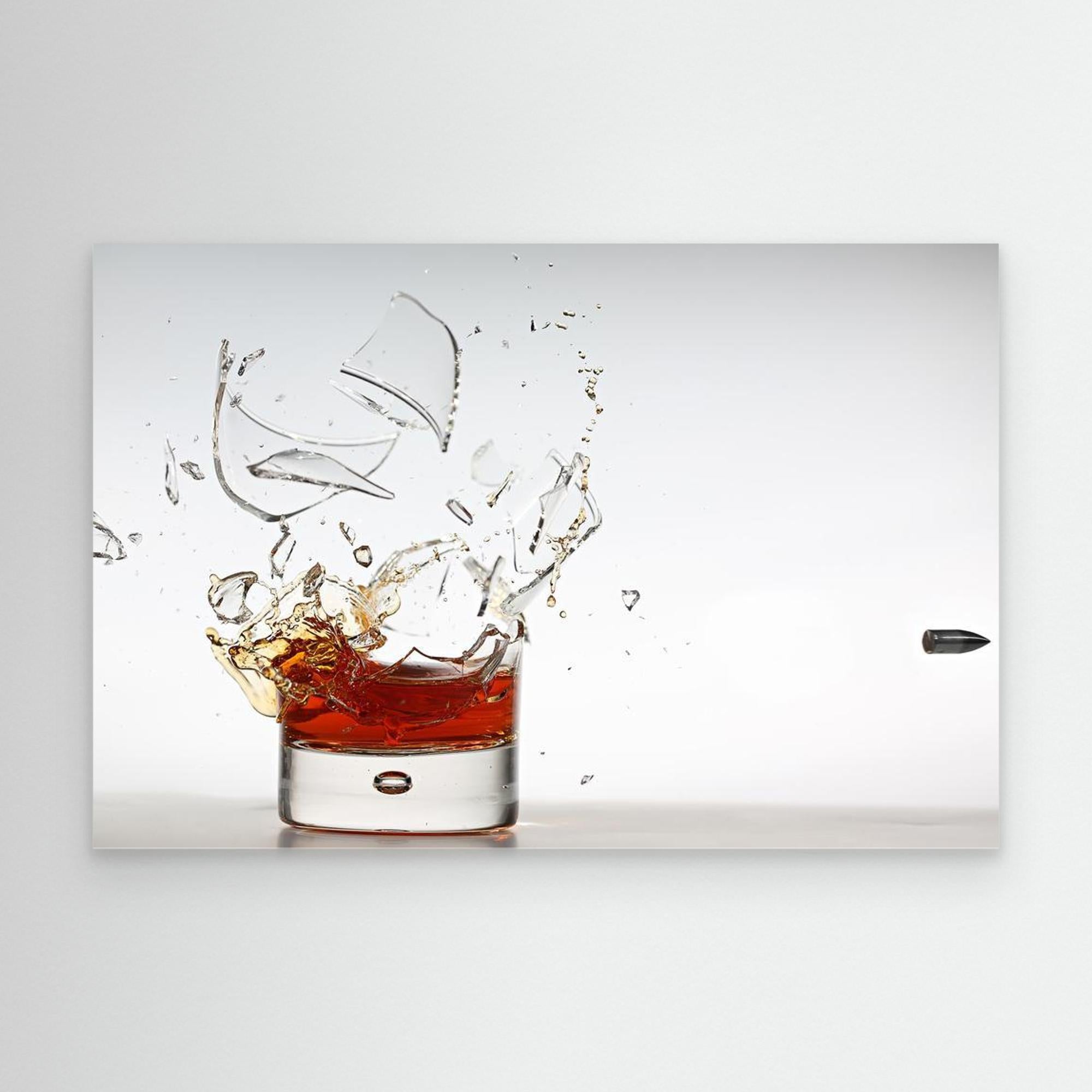 Glass of whiskey with a splash on a white background
