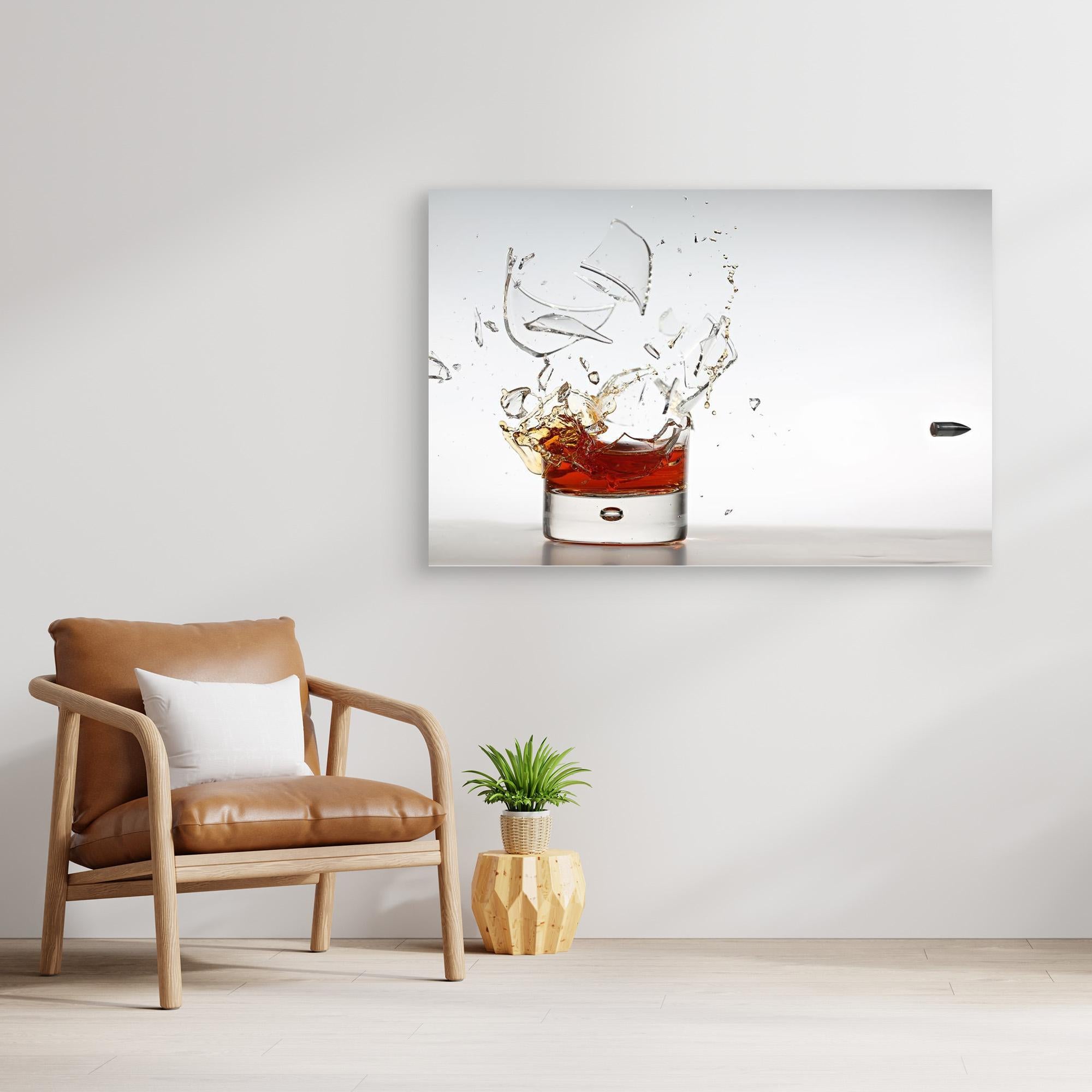 Modern interior with a brown leather chair, plant, and abstract painting of a glass with liquid.