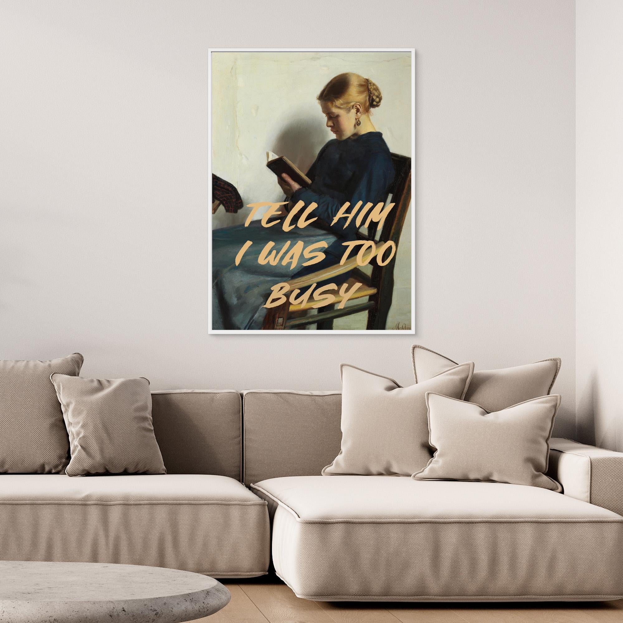 Print with text on a wall above a beige sofa